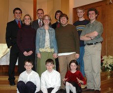 the 11 cousins with a poinsettia in the background
